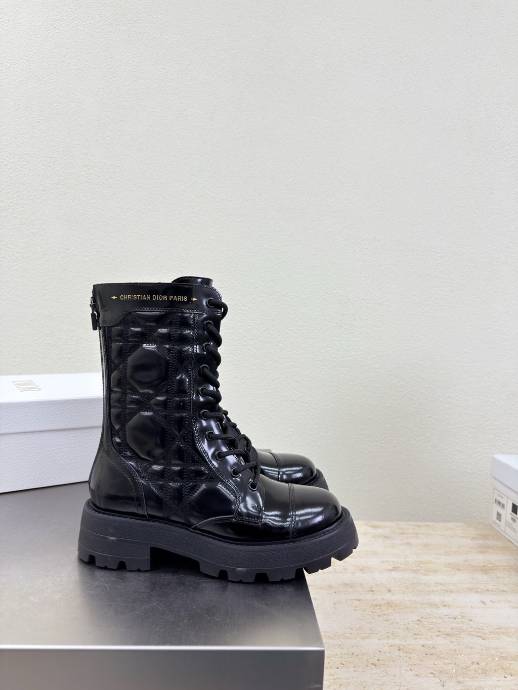 Black lace-up combat boots with chunky lug sole and metal eyelets