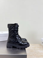 Black lace-up combat boots with chunky lug sole and metal eyelets