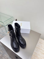 Black leather ankle boots with side zipper and chunky lug sole