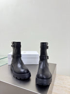 Black leather mid-calf boots with ankle buckle and chunky platform sole