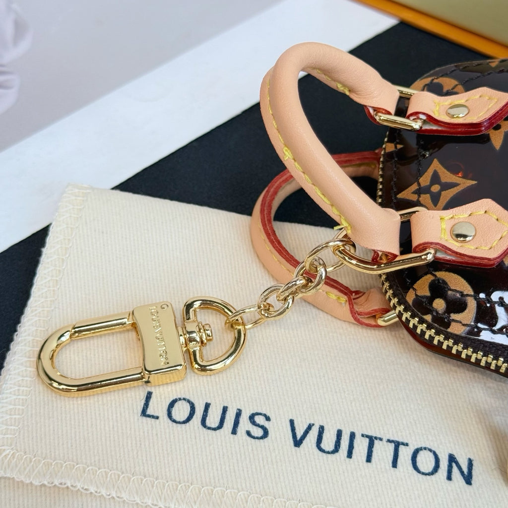 Louis Vuitton monogram mini handbag keyring with metal clasp and tan handle