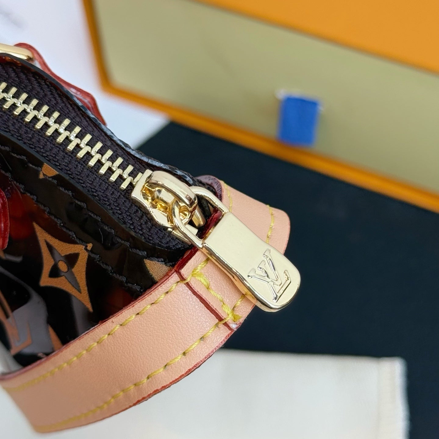 Louis Vuitton monogram mini handbag zipper pull with gold-tone clasp and pink strap