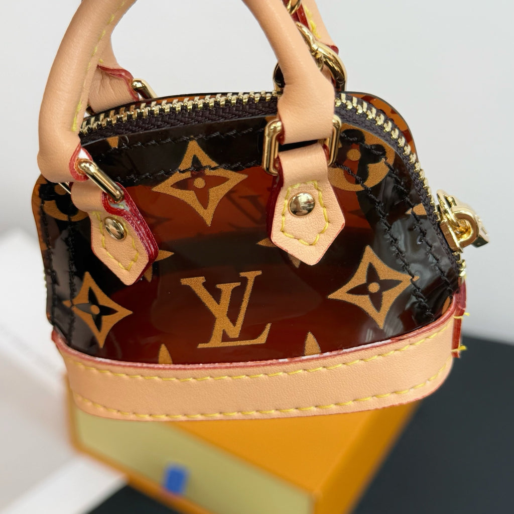 Louis Vuitton monogram mini handbag with zipper opening and pink-trim strap
