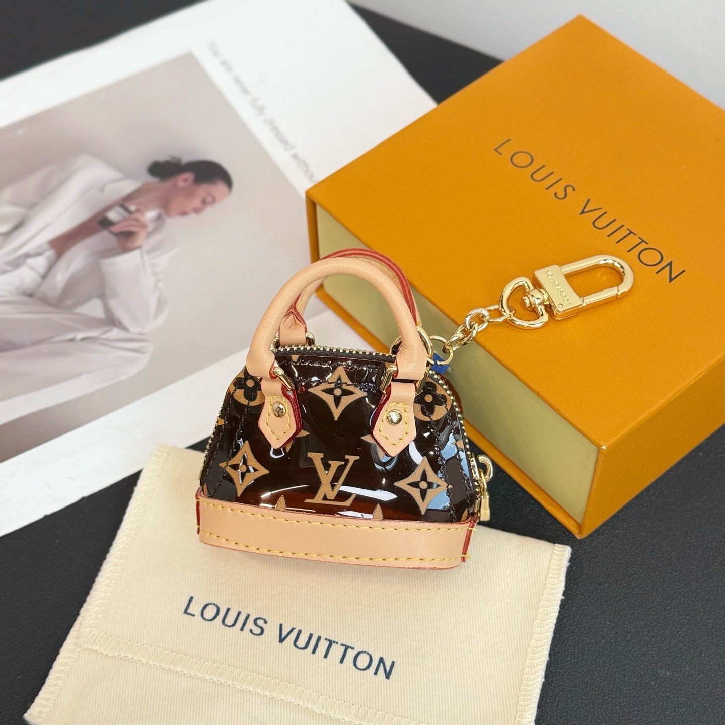 Louis Vuitton monogram mini handbag with chain keyring and pink leather handles