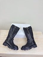Pair of black knee-high boots with buckle straps and side zippers, front view