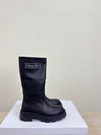 Women's dark knee-high boot with Christian Dior label and chunky lug sole
