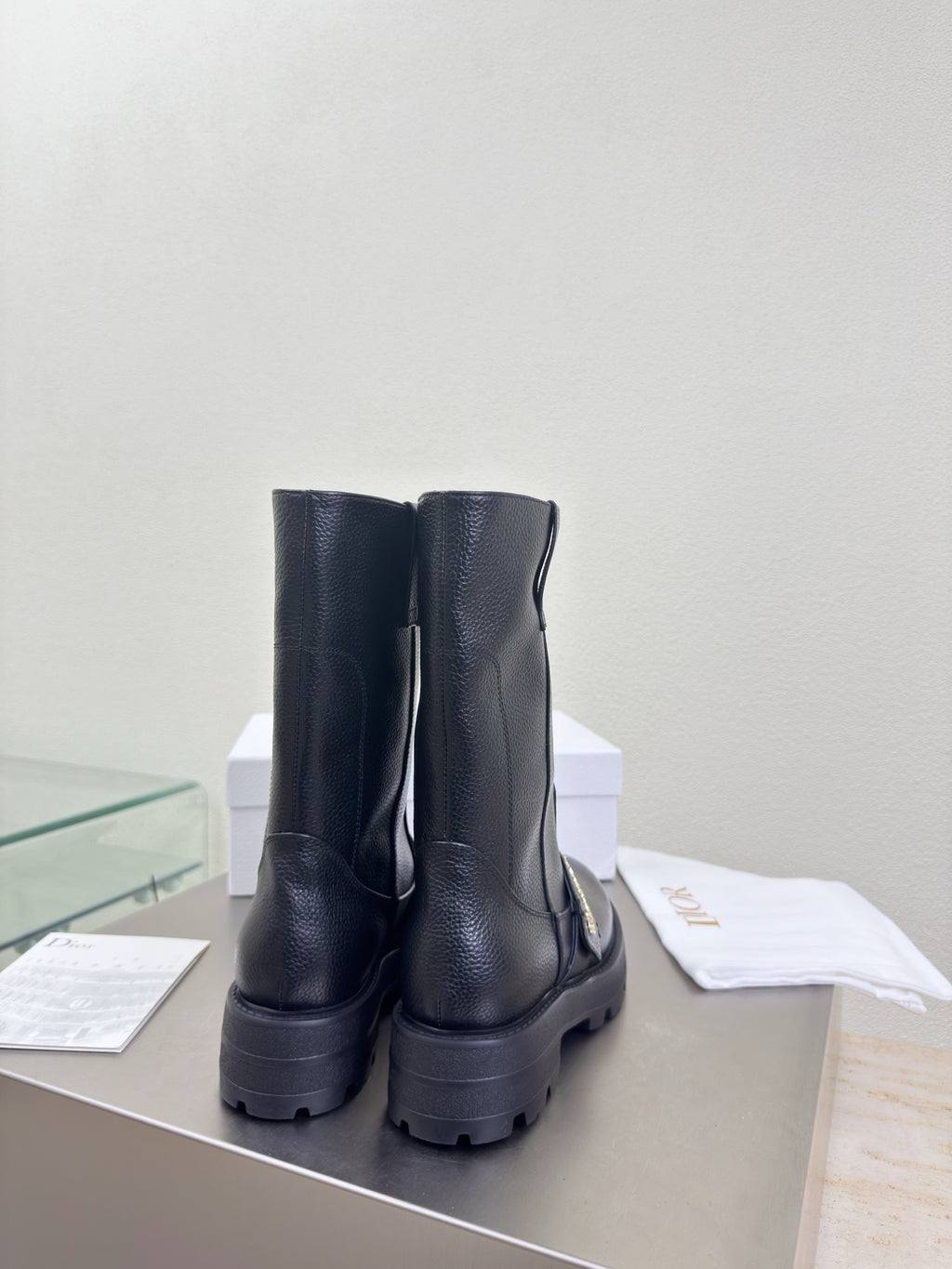Dior ladies back view of mid-calf leather boots, dark pull-on with stacked heel