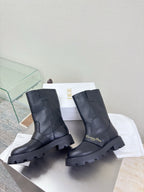 Dior ladies mid-calf leather boots, dark, front view with chunky lug sole