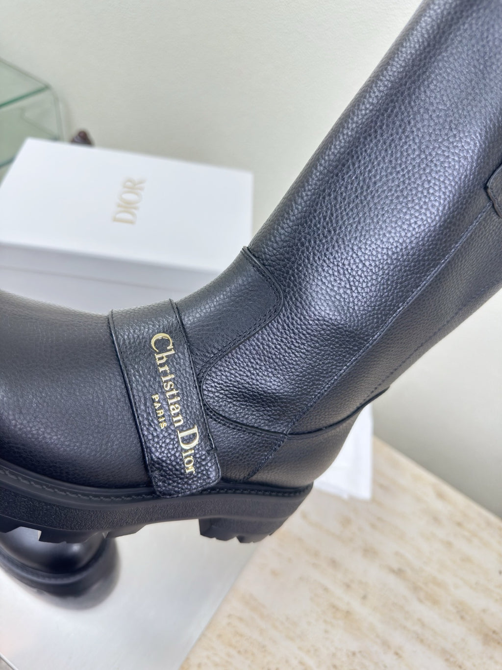 Dior ladies boot upper detail with stitched strap and gold brand label