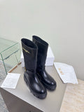 Women's black quilted leather mid-calf boots with buckle strap and lug sole