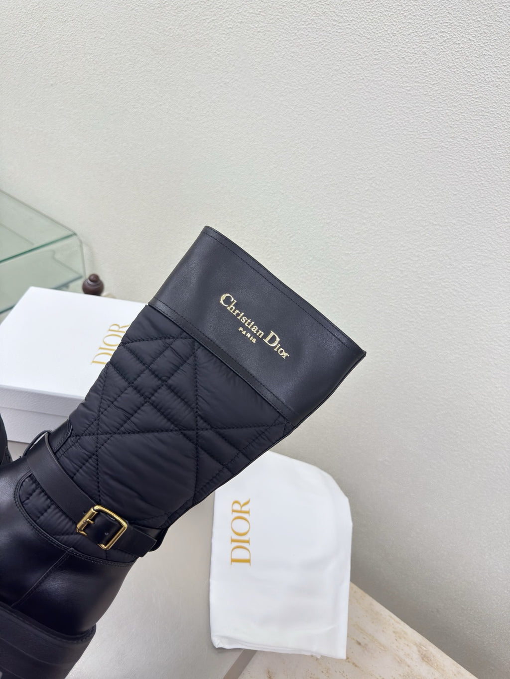 Women's black quilted mid-calf boots with gold buckle and Christian Dior logo