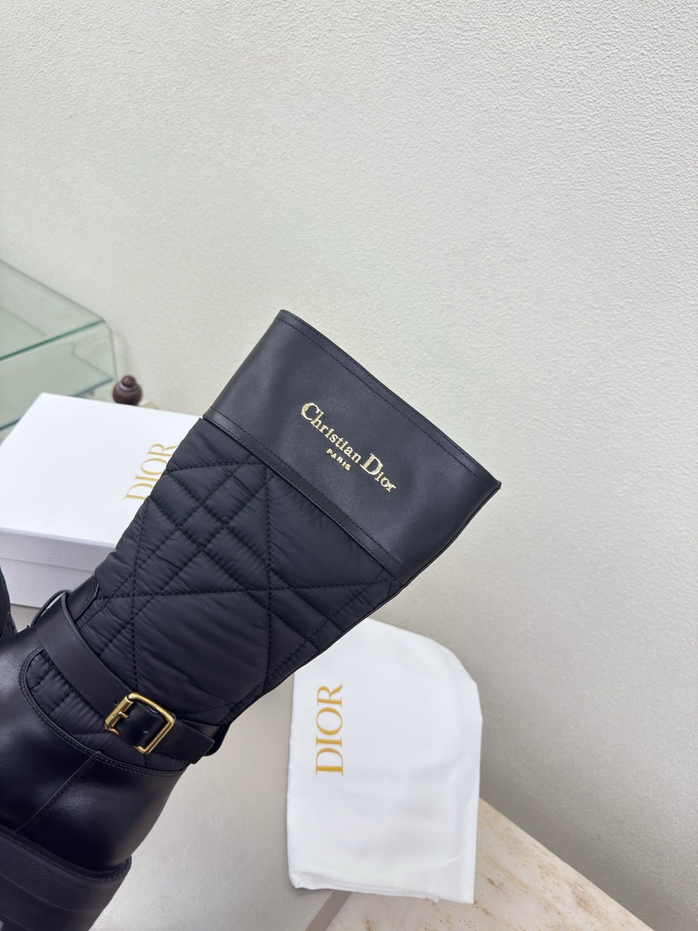 Women's black quilted mid-calf boots with gold buckle and Christian Dior logo