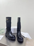 Women's black quilted mid-calf boots with buckle strap and chunky tread sole