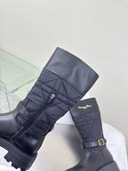 Women's black quilted mid-calf boots with adjustable buckle strap and side logo