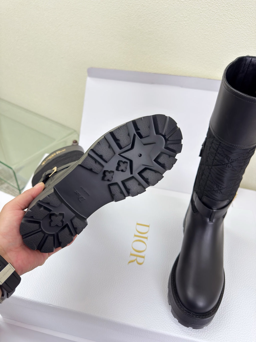 Women's Dior knee-high boot outsole and side view with dark lug tread