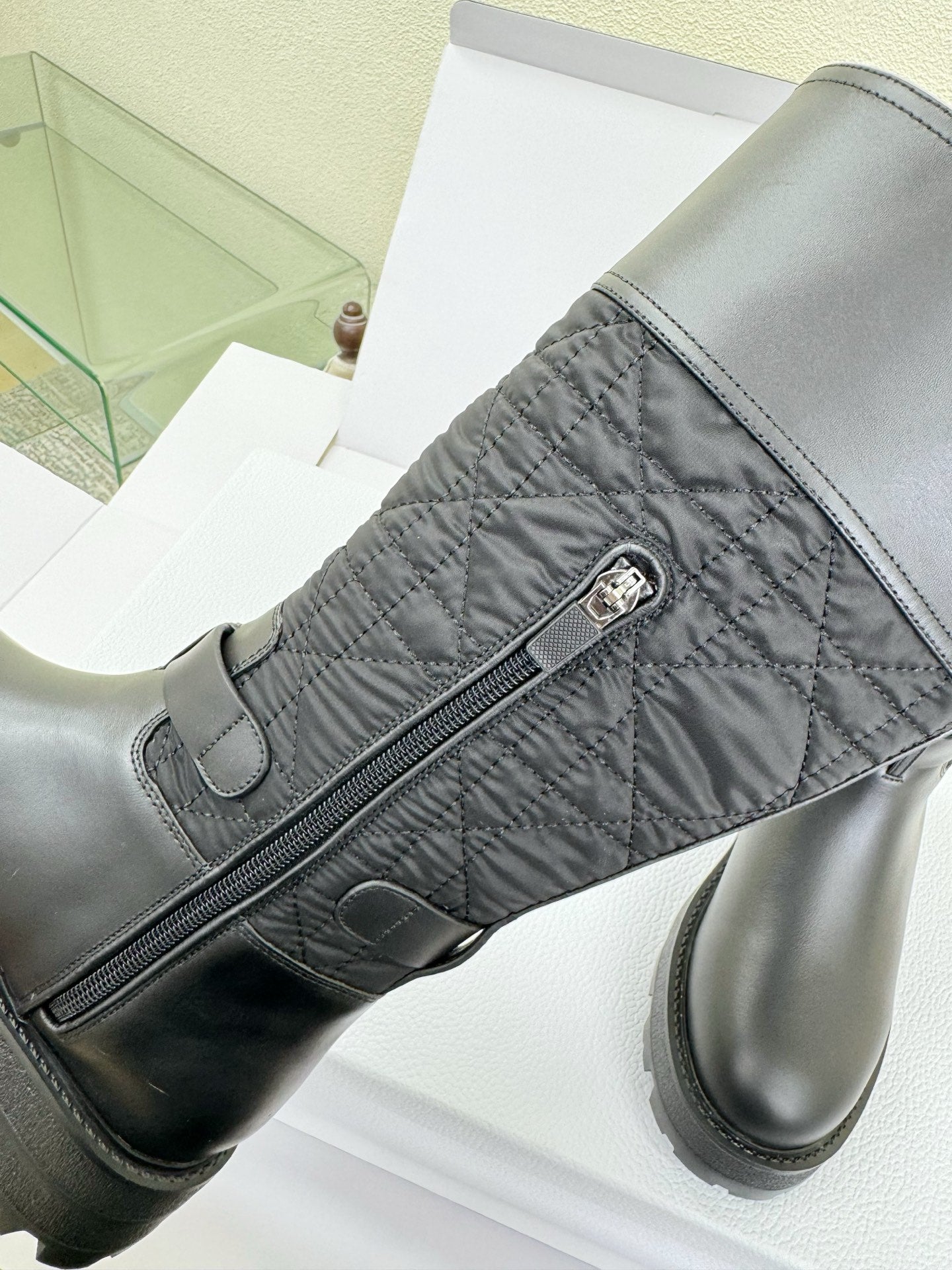 Women's Dior knee-high boot with diagonal zipper and metal pull tab detail