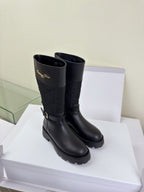 Women's Dior knee-high boots in dark black, quilted shaft and lug sole
