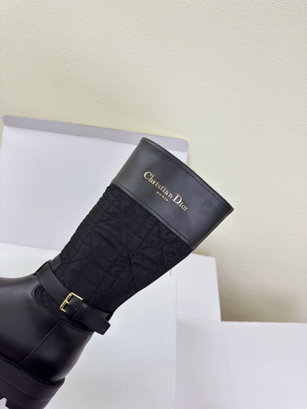 Women's Dior knee-high boot with gold buckle strap and quilted shaft