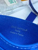 Louis Vuitton small bag close-up: blue leather with Louis Vuitton Paris text