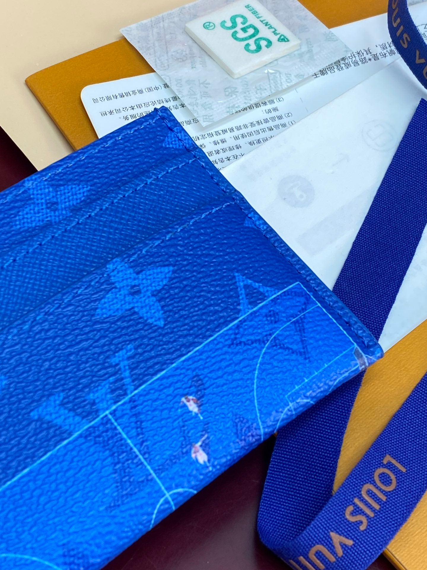 Louis Vuitton small bag close-up in blue monogram leather with blue strap