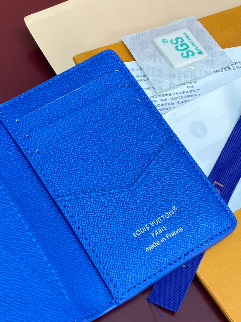 Blue small bag detail view with Louis Vuitton logo and “made in France”
