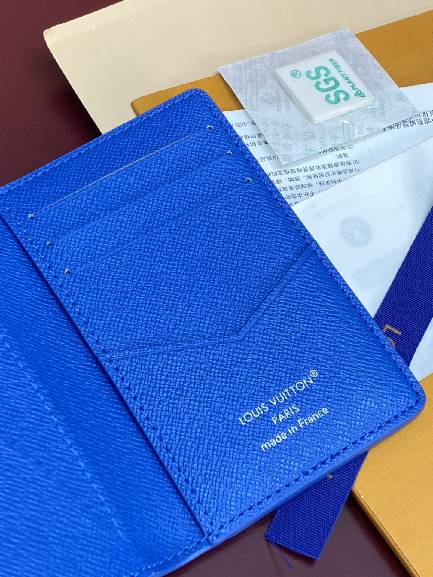 Blue small bag detail view with Louis Vuitton logo and “made in France”