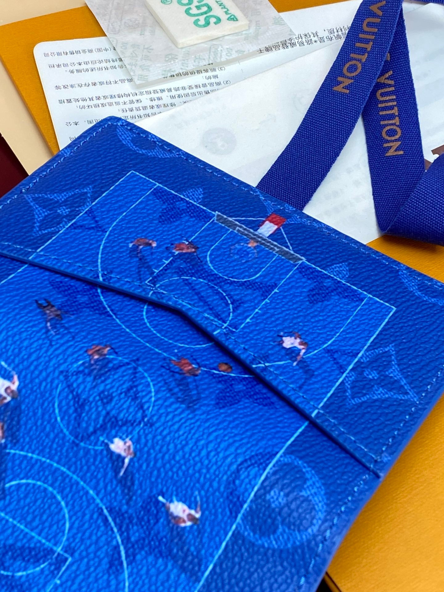 Blue small bag close-up with Eiffel Tower motif and patterned artwork