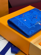 Blue small bag rolled on its side, featuring a printed motif on the flap