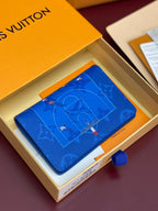 Blue small bag with printed motif and smooth flap, shown on its box