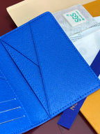 Blue small bag close-up of flap folds and stitched leather texture