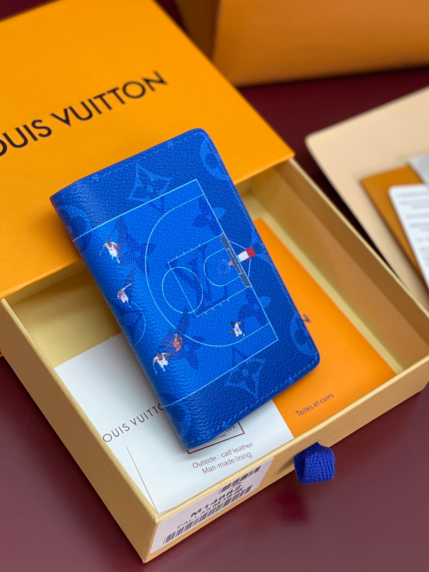 Blue small bag with printed map motif and visible Louis Vuitton branding