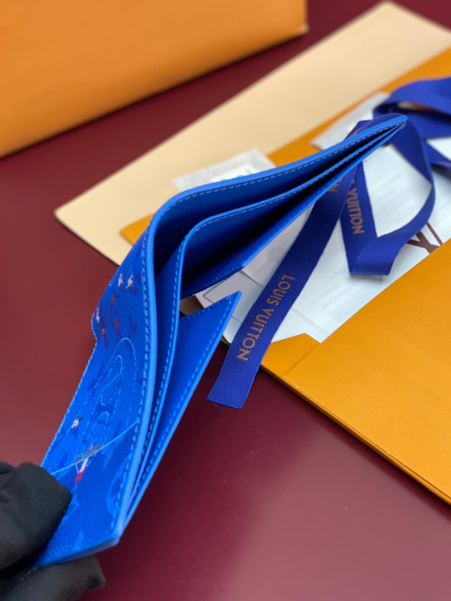 Blue Louis Vuitton small wallet with wrist strap and printed logo tape