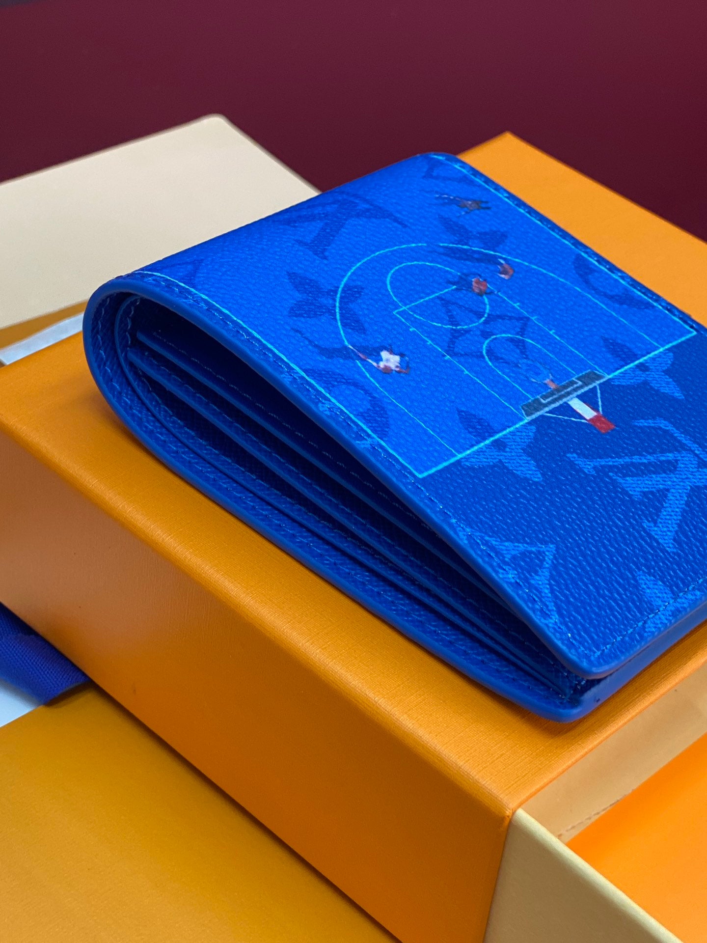 Blue Louis Vuitton small wallet folded with monogram lining on box