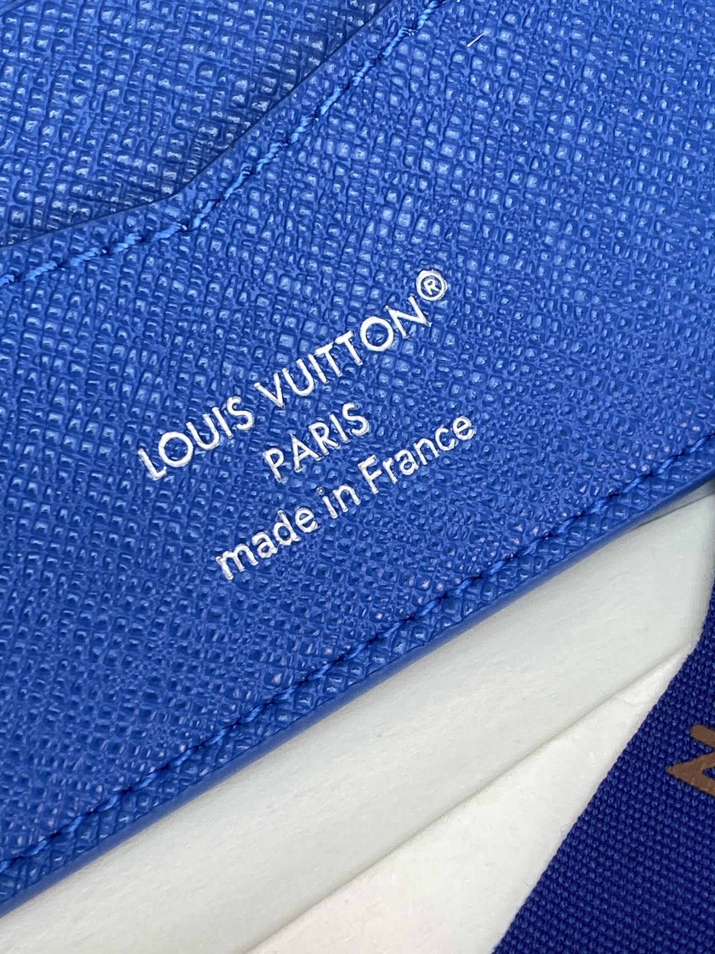 Blue Louis Vuitton leather wallet with 'made in France' stamp