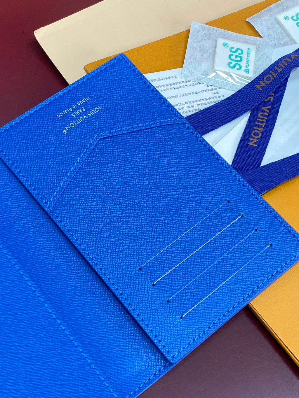 Blue small bag close-up showing card slot stitching and metal snap