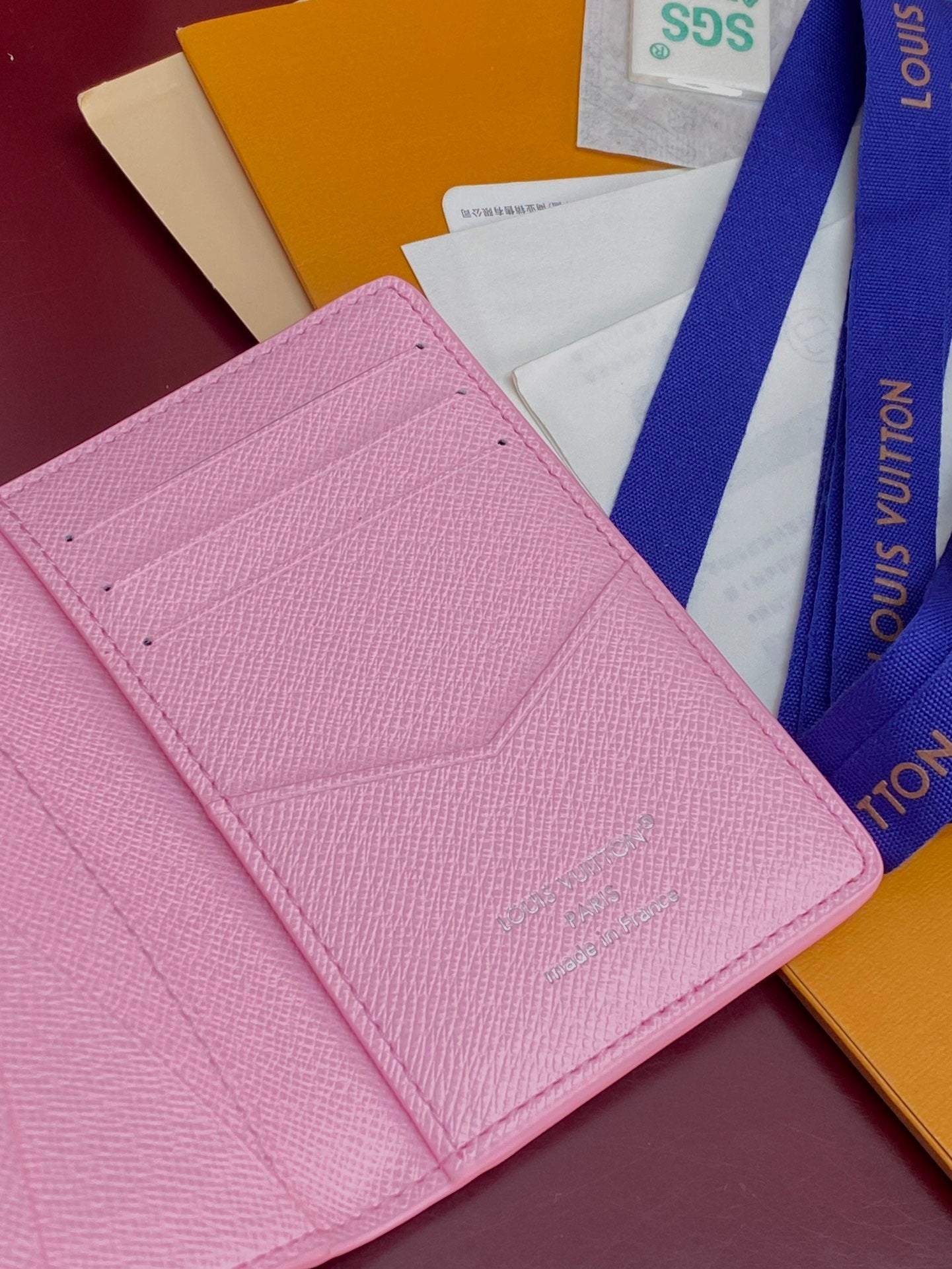 Pink Louis Vuitton small bag interior with stitched card-slot panel.