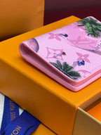 Pink Louis Vuitton small bag with tropical print and rounded edge.