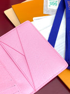 Pink Louis Vuitton small bag open with interior card slots.