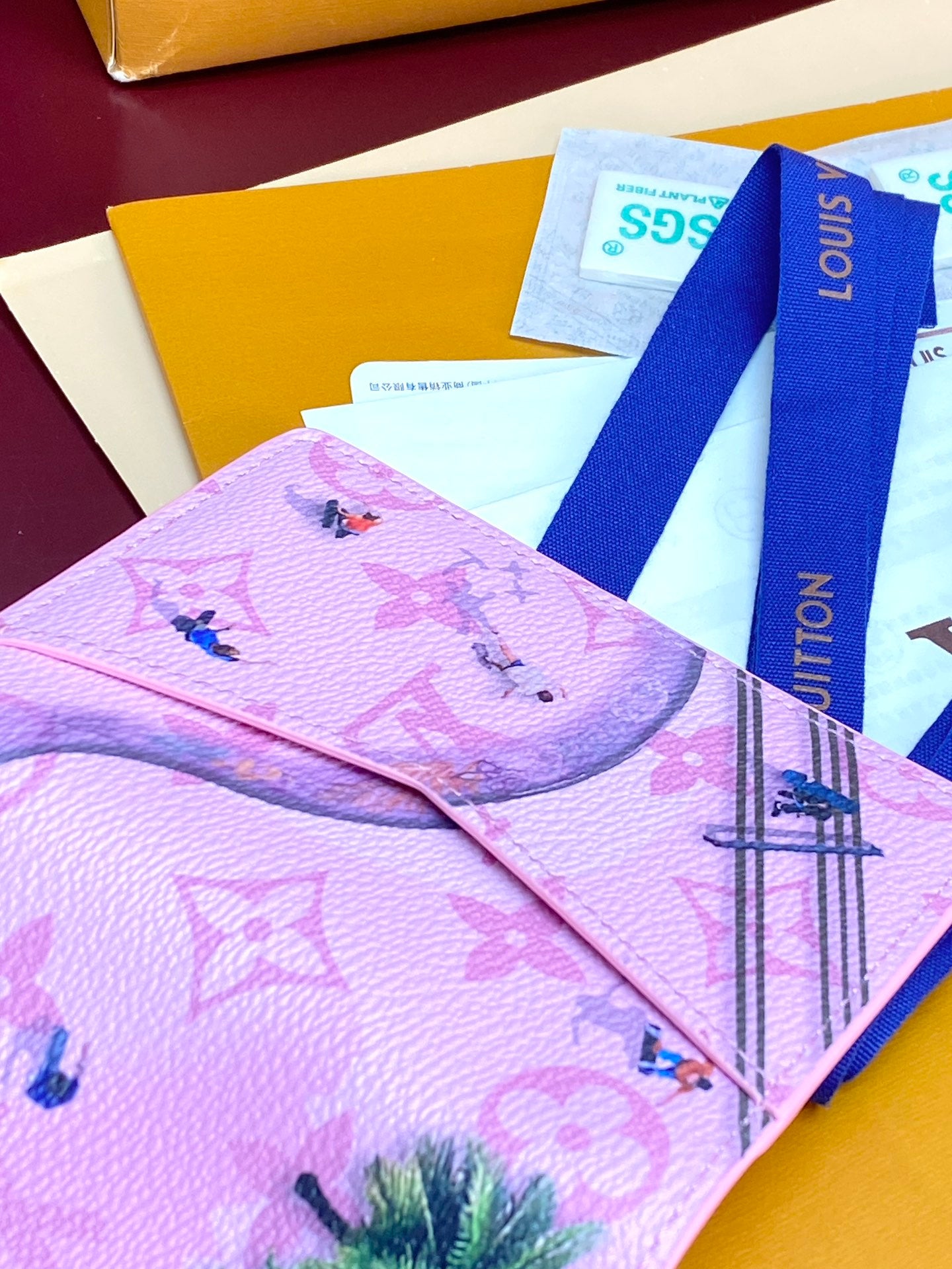 Pink Louis Vuitton small bag open, tropical birds and Eiffel Tower print.