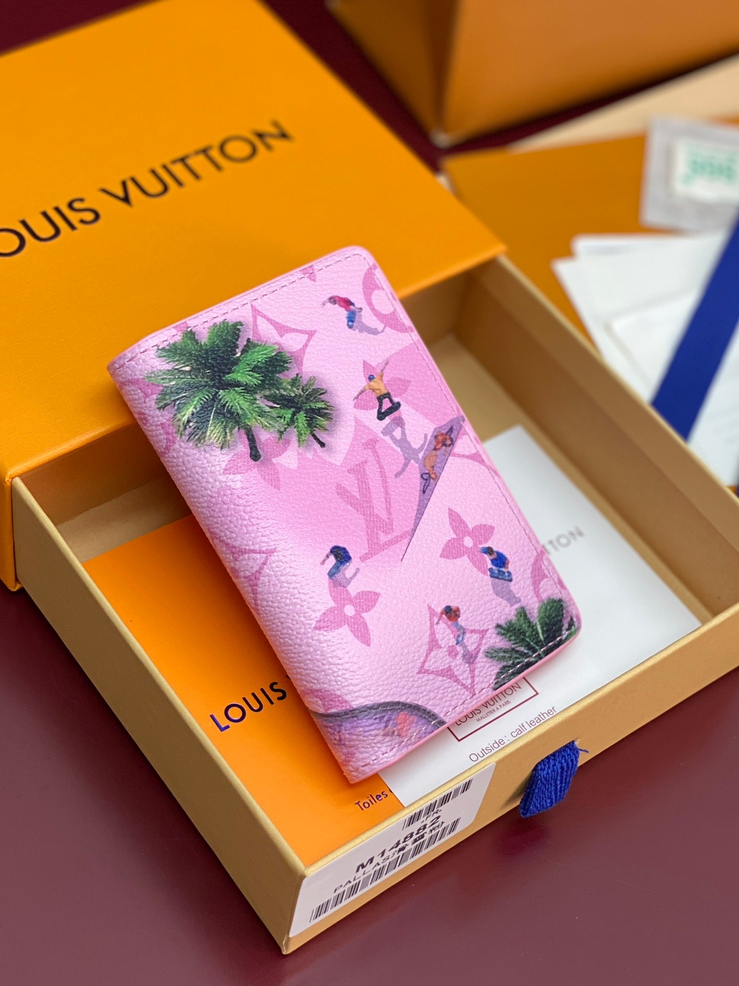 Pink Louis Vuitton small bag with tropical print, palm trees and birds.