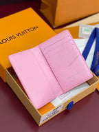 Pink Louis Vuitton small bag with textured leather and fold-over flap.