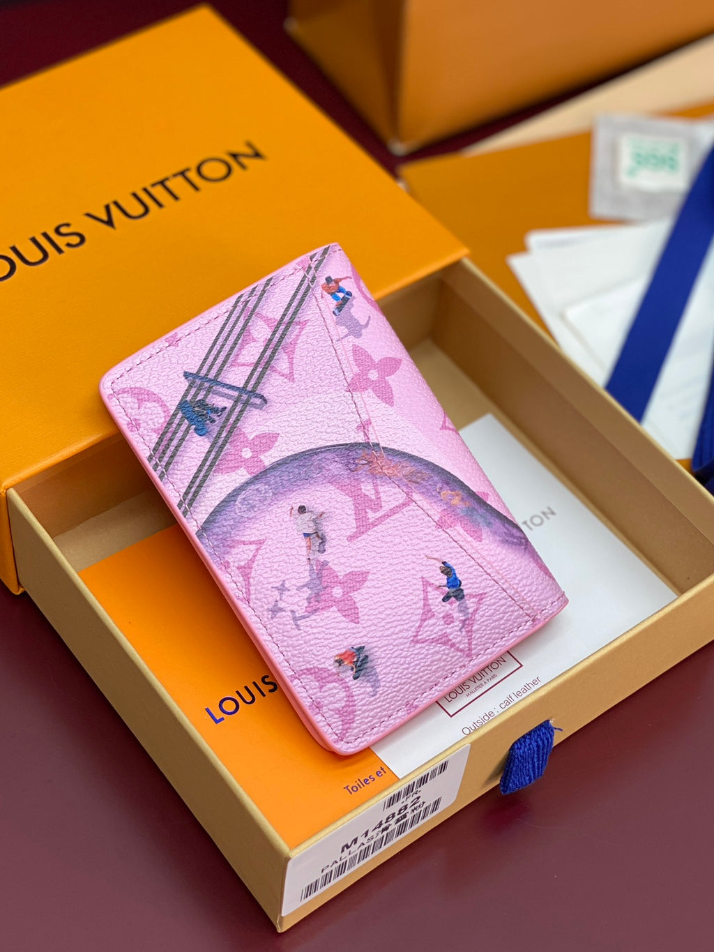Pink Louis Vuitton small bag with Eiffel Tower and tropical birds print.