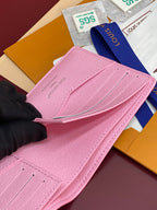 Pink small bag with flap open, showing textured leather and Louis Vuitton logo