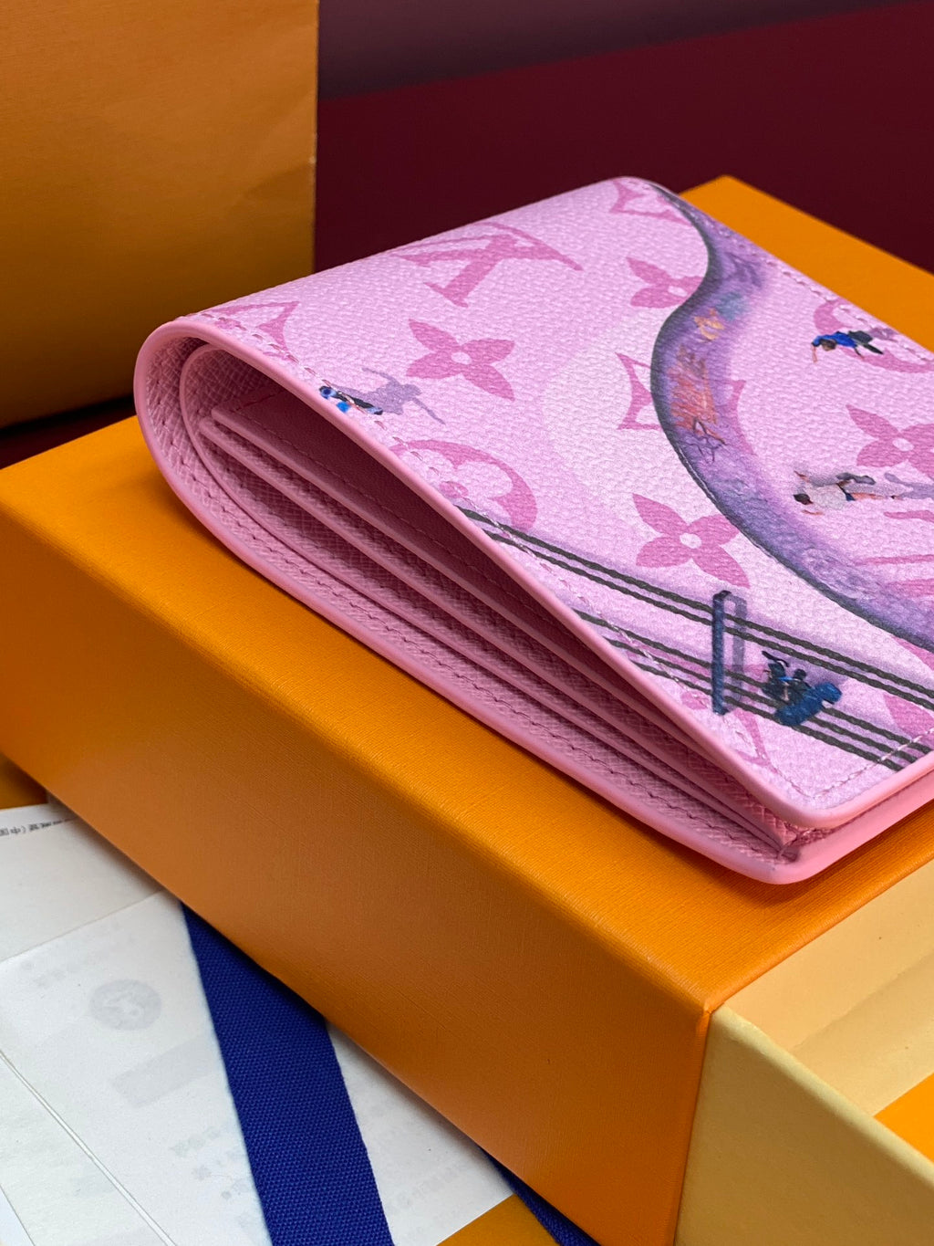Pink rolled small bag with multicolor Louis Vuitton monogram print