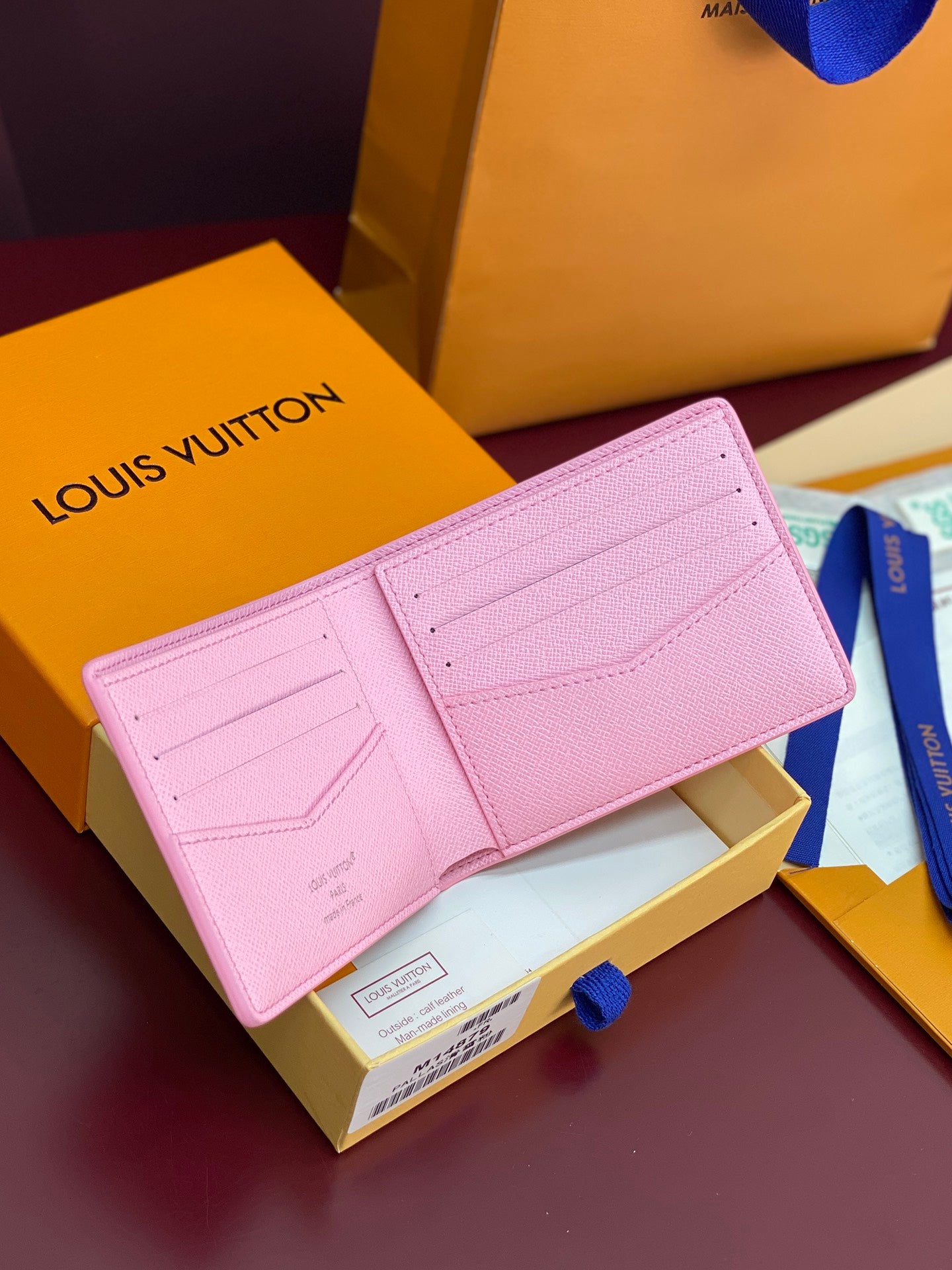Pink bi-fold small bag with flap closure and stitched card slots; Louis Vuitton