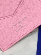 Louis Vuitton pink small bag close-up of embossed 'Louis Vuitton Paris' text