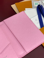 Pink small bag close-up of textured surface and stitched card-slot panel
