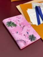 Small bag with pink monogram print and palm tree motif, angled view