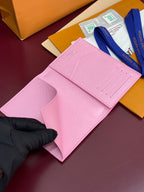 Pink small bag wallet with card slots and fold-over flap, laid flat