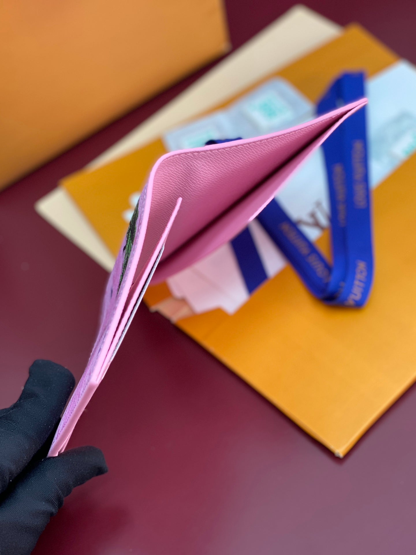 Pink small bag open to show interior and fold-over flap